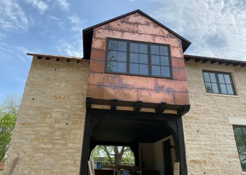 Copper metal panel facade on a stone building for Skylight Installation in Stickney